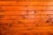 Horizontal pine wood boards painted in orange color
