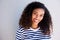 Horizontal portrait of beautiful young african woman smiling against white wall