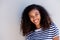 Horizontal portrait of happy young african woman smiling against white background