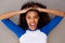 Horizontal portrait of happy young black woman with hand in hair