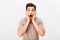 Horizontal portrait of scared man grabbing his face and screaming in stress, isolated over white background