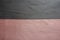 Horizontal seam between grey and pink artificial suede