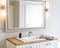 Horizontal shot of a bathroom mirror and a sink at a nicely designed bathroom