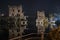 Horizontal shot of beautiful Italian castles connected with a bridge over the lake at nighttime