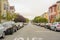 Horizontal shot of a beautiful street with trees, parked cars and classic San Francisco houses on both sides, California - United