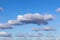 horizontal shot of blue sky with puffy white clouds. Meteorology, climate