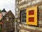 Horizontal shot of a brown building with a red and yellow window covering during daytime