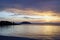 Horizontal shot. Empty beach in the evening at sunset. . Silhouettes and coastline. Sea bright sky.