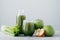 Horizontal shot of freshly blended apples and cerely for your healthy eating. Vegetarian green drink in glasses. Detox beverage,