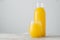 Horizontal shot of freshly squeezed orange juice made of citrus in glass containers, isolated over white background with blank