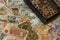 Horizontal shot of a handful of numismatic collection banknotes and a wooden box with coins from various countries of the world in