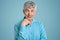 Horizontal shot of mature grey haired Caucasian male pensioner wears elegant shirt, keeps hand under chin, poses for making photo