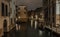 Horizontal shot of an old neighborhood in Venice, Italy and a river with boats for transportation