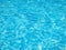 Horizontal shot of pure light blue water in a swimming pool
