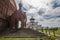 Horizontal shot of a red-bricked church with another church in the background in Yuryev-Polsky
