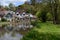 Horizontal shot of a river flowing near houses in Guildford, England