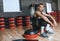 Horizontal shot of sporty athletic man sitting on stepper relaxing after exercises in the gym.Fitness tired trainer male rest