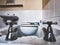 Horizontal shot of a steel bath taps on a background of a toilet seat in a dirty bath and sink