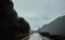 Horizontal shot of a truck on a mountain pass on a cloudy and rainy day