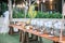 Horizontal shot of a wedding table setting outdoors with silver pots and a lot of plates