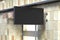 Horizontal signboard or signage on the black wall with blank luminescent sign mock up. Side view