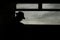 Horizontal silhouette shot of a lonely male with a hat on the train