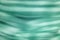 Horizontal strip bright saturated green blurred wave abstraction, pattern