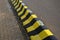 Horizontal stripes for traffic signs. highway concrete barriers on the road. vehicle lane separator. yellow color with black strip