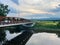 Horizontal sunset view of the Carmine Liberta Memorial Bridge, a two-lane steel through truss