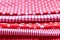 Horizontal textural background of five types of red and white cotton fabric with different prints