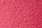 Horizontal texture of red concrete wall for background and design. Rough and uneven terrain. Interior option