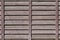 Horizontal texture of a wall from several rows of brown old wooden boards. Painted wooden wall in brown colo