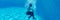 Horizontal underwater photography girl falling in blue water of swimming pool