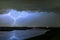 Horizontal and vertical lightning bolts from a severe thunderstorm over a lake in the western part of Holland