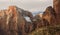 Horizontal view of The Alter of Sacrifice in Zion National park with it`s red and yellow sandstone cliffs topped by snow