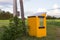 Horizontal view of cute handmade yellow school bus shelter seen during a summer late afternoon in a rural area