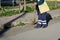 Horizontal View of a Dustman Working in the Street Using a Wooden Mop and Dressing a Yellow Jacket