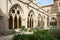 Horizontal view of the Gothic arches from the cloister garden of the Cistercian Monastery of Poblet, Tarragona, Spain