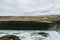 Horizontal view of Gullfoss waterfall in Southwest Iceland. Blue and green water with pale white splashes flying over it