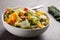 Horizontal view of large white porcelain bowl of pasta and roasted vegetables