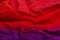 Horizontal view of red and purple fabric texture background. Red and purple color textile backdrop.