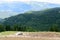 Horizontal view with sheepfold and mountains. Wooden sheepfold i