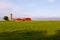 Horizontal view of a St. FranÃ§ois village farm with bright orange buildings and tall silo