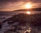 Horizontal view of sunset at Otter Point in Acadia National Park, Maine. Waves