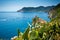 Horizontal View of the Town of Vernazza on blue Sea and the Coastline of the Liguria Background.