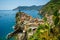 Horizontal View of the Town of Vernazza on blue Sea and the Coastline of the Liguria Background.