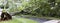 Horizontal view of tree that fell over driveway and wires during a tropial storm