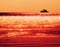 Horizontal vivid orange ship silhouette in ocean