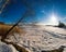 Horizontal vivid winter landscape with sun rays and footprints