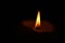 Horizontal wallpaper background burning candle in the dark close up